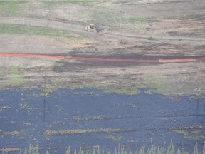 Crews work to clean the spill of bitumen, water and sand by  Nexen's Long Lake facility near Fort McMurray