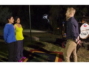 Longtime friends Susan Hayre, left, and Sharnjit Gill learn they have been eliminated from The Amazing Race Canada from host Jon Montgomery in Santiago, Chile.