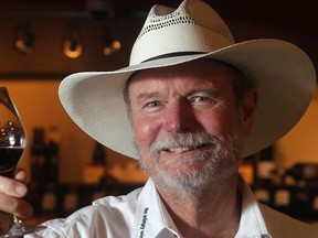 Joel Peterson, one of the wealthiest Americans and the godfather of Zin, holds a glass of his Ravens Wood wine Thursday July 10, 2015 during a tasting event at The Cellar Wine Store in Calgary.