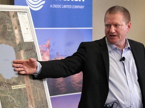 Ron Bailey, senior vice-president of Nexen's Canadian operations, points to a map showing the location of a pipeline oil spill near the Long Lake oilsands operation.