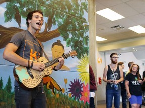 Stampede Talent Search winner Christian Hudson sings for Calgary Drop-In Centre staff and clients on Friday after presenting the $10,000 prize money he won for the winning the Calgary Stampede talent contest.