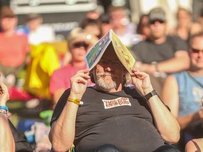 Music lovers bask in the sun at the Calgary Folk Music Festival.