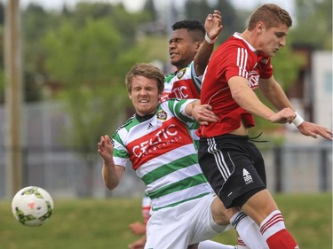 Foothills FC's Dean Northover, front left, and Jean-Pierre Rodreigues-Lemos, jump to head the ball against Lane United FC's Jordan Jones during men's soccer action at Hellard field in Calgary, on July 15, 2015.