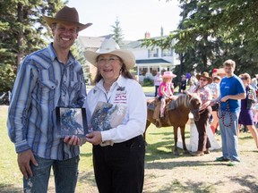 Sean Green (on behalf of the Garrison Woods Community Breakfast) receives the Spirit Recognition Award from Freddy Taylor of the Calgary Stampede at the Garrison Woods Stampede Breakfast in SW Calgary on July 4th, 2015.