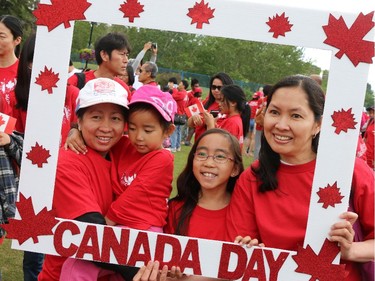 The Eusebio family poses in patriotic picture frame on Prince's Island on Canada Day 2015.