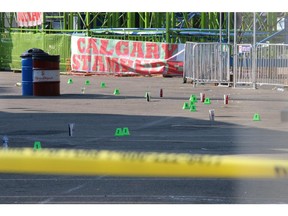 Evidence makers indicate the large scene of a triple stabbing on the Calgary Stampede midway. One person was reported in critical condition on July 9, 2015.