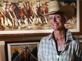 Artist Jody Skinner was photographed in her booth at the Calgary Stampede. One of Skinner's paintings was the top selling painting in this year's art auction, selling for $14,000.