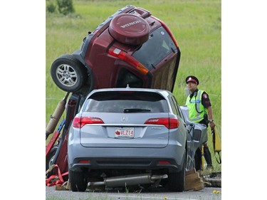 Police and firefighters attend the scene of a fatal head on collision on 14th Street N.W. just south of Berkshire Blvd on Wednesday July 22, 2015. Two SUVs collided with one approximately 60 year-old female deceased on the scene and a second 40 female taken to hospital in serious condition.