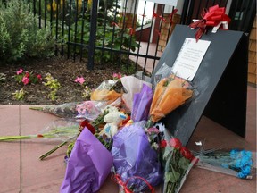 Red ribbons and flowers decorate the entrance to Auburn Lake the day after a boy drowned in the lake.