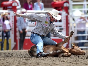 Tuf Cooper, seen competing at the 2014 Calgary Stampede, was kicked out of this year's tie-down roping event for whipping his horse too much.