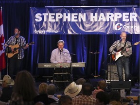 Stephen Harper sings with the Vans Cats at the 11th annual Calgary South West Stampede BBQ at Heritage Park in Calgary on Saturday, July 4, 2015.