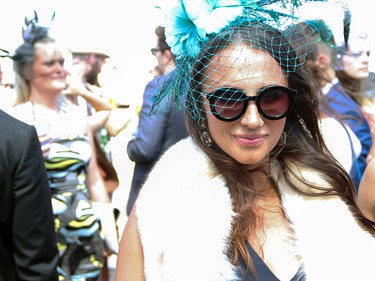 I love the combination of fur, shades and a brilliantly coloured fascinator.