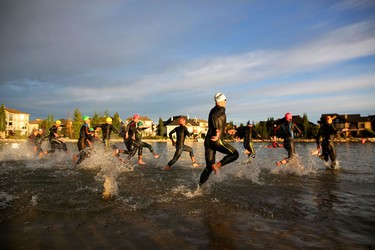 Athletes take to the water during the start of the Ironman 70.3 Calgary at Auburn Bay on July 26, 2015.