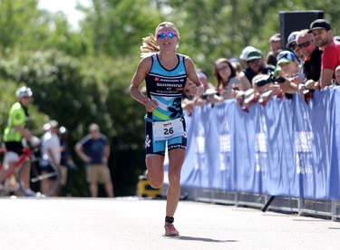 Magali Tisseyre crosses the finish line with a top ladies time during the Ironman 70.3 Calgary at Auburn Bay on July 26, 2015.