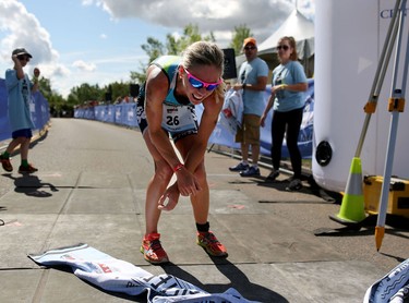 Magali Tisseyre crosses the finish line with a top ladies time during the Ironman 70.3 Calgary at Auburn Bay on July 26, 2015. Tisseyre was later disqualified.