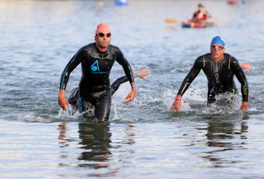 Athletes leave the water during the end of the swimming portion of Ironman 70.3 Calgary at Auburn Bay on July 26, 2015.