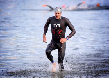 Andy Potts is first out of the water during the Ironman 70.3 Calgary at Auburn Bay on July 26, 2015.