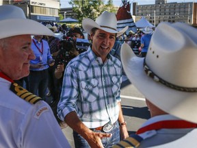 Liberal Leader Justin Trudeau greets spectators during the Calgary Stampede parade in Calgary, Friday, July 3, 2015.
