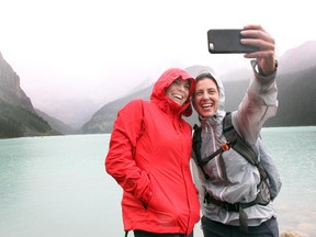 Friends Mindy Hamilton, left, and Maura Hamilton from Austin, TX. stopped to take a selfie photo of themselves on the banks of Lake Louise while visiting on July 23, 2015. Maura is currently on a three week road trip which is including stops in Lake Louise and Jasper.