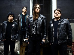 Laura Jane Grace, centre, is the frontwoman for American punk act Against Me!.