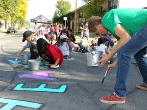 Many communities in Calgary are creating their own "traffic calming" solutions. The Sunalta Community Association commissioned Calgary's celebrated mural artist Dean Stanton, right, to work with neighbourhood children to paint murals on intersections as a traffic calming project in front of Sacred Heart Elementary School.