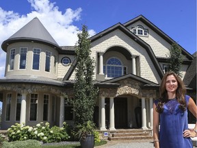 Tanya Eklund, realtor, stands in the driveway of the home of golfer Stephen Ames which is listed at $8 million in Calgary.