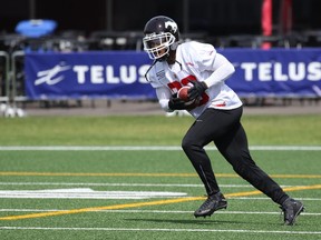 Calgary Stampeders wide receiver Nathan Slaughter runs with the ball at practice on Tuesday.