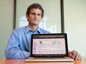 Graham McMillan poses for a portrait with the website he started to expose a Ponzi scheme that his parents had invested in, Oct. 2, 2009 in San Diego, California.