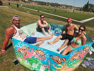 From left, Zsigmond Fekete, Caden Sawatzky Josh Doiron and Kelsey Sapieha brought their own pool to keep cool as they watched Calgary Foothills DC take on the Seattle Sounders at Hellerd Field on Sunday afternoon.