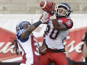 Montreal Alouettes defensive back Jerald Brown (39) breaks up the pass as Calgary Stampeders wide receiver Eric Rogers fails to make the catch during first half CFL football action in Montreal, Friday July 3, 2015.