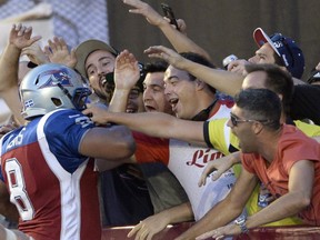 Montreal Alouettes slotback Nik Lewis (8) celebrates his touchdown against the Calgary Stampeders with fans during first half CFL football action in Montreal, Friday July 3, 2015.