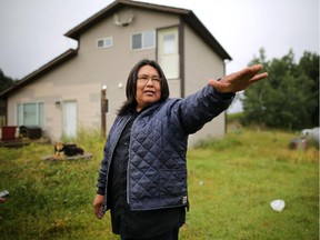 Stoney Nation resident Henry Ear outside his home that was ruined by the floods of 2013.