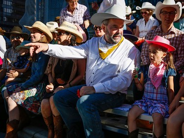 NDP Leader Tom Mulcair, left, and his granddaughter Juliette, six, attend the Calgary Stampede parade.