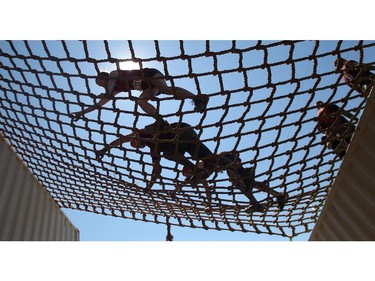 Competitors clamber over the netting of the Mount Maniac portion of the Rugged Maniac obstacle course Saturday July 18, 2015 at Rocky Mountain Show Jumping. Hundreds of adventurers ran, climbed and slogging through a 5 kilometre course of ropes, towers, mud and fire. The show travels across North America with it's next Canadian stop in Vancouver August 15.