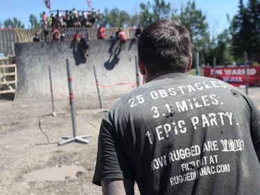 Competitors are pulled up the Warped Wall at the Rugged Maniac obstacle course Saturday July 18, 2015 at Rocky Mountain Show Jumping. Hundreds of adventurers ran, climbed and slogging through a 5 kilometre course of ropes, towers, mud and fire. The show travels across North America with it's next Canadian stop in Vancouver August 15.