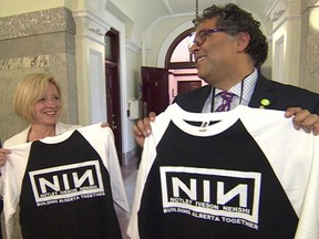 Alberta Premier Rachel Notley and Calgary Mayor Naheed Nenshi show off their "Notley Iveson Nenshi" T-shirts to reporters at the Alberta legislature.