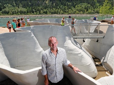 Artist Brian Tolle stands in front of his piece Outflow which is the focal point of the newly opened Parkdale Plaza. Outflow is also functional art with storm sewer water flowing through the piece helping to clean it before entering the Bow River.
