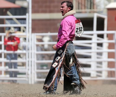 Will Lowe of Canyon, Texas celebrates his score during the Calgary Stampede Bareback Championship.