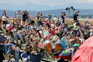 Crowds look to the skies during the Wings Over Springbank air show at Springbank Airport west of Calgary on July 19, 2015.