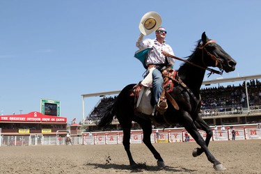 Kaycee Field of Spanish Fork, Utah, celebrates his win during the Calgary Stampede Bareback Championship.