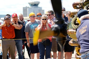 people plug their ears during the starting of Bristol Hercules engine during the Wings Over Springbank air show at Springbank Airport west of Calgary on July 19, 2015.