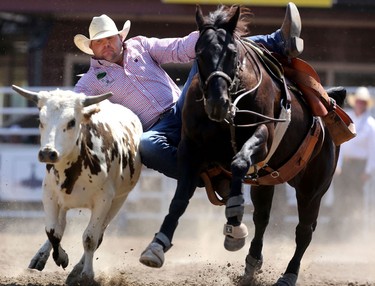 Clayton Moore of Pouce Coupe, BC during the Calgary Stampede Steer Wrestling Championship.