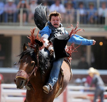 Dustin Shaver of Crooked Creek, Alberta rides Xplicit Pride during the Calgary Stampede Novice Bareback Championship.