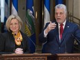 Quebec Premier Philippe Couillard, right, responds to reporters questions as Alberta Premier Rachel Notley looks on, Tuesday, July 14, 2015 at a joint news conference in Quebec City.