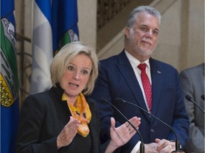 Premier Rachel Notley responds to reporters' questions as Quebec Premier Philippe Couillard looks on Tuesday in Quebec City.