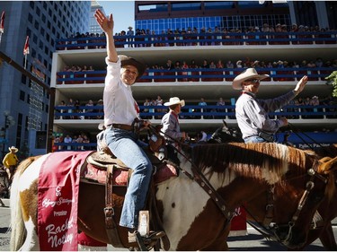 Alberta Premier Rachel Notley waves to the crowd during the Calgary Stampede parade in Calgary, Friday, July 3, 2015.