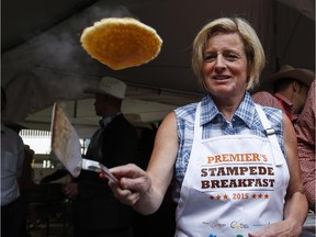 Alberta Premier Rachel Notley flips pancakes at the annual Premier's Stampede breakfast in Calgary on Monday, July 6, 2015.