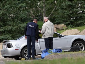 Investigators collect evidence from the scene of Ali Khamis' killing in the Shawnessy Community Association parking lot in 2006.