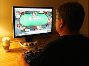 Manassas, UNITED STATES:  A man plays poker on his computer connected to an internet gaming site from his home in Manassas, VA 02 October, 2006.  US President George W. Bush this week is expected to sign a bill making it harder to place bets on the Internet, a practice which already is illegal in the United States. Bush was expected to act quickly after Congress approved the Unlawful Internet Gambling Enforcement Act, making it illegal for financial institutions and credit card companies to process payments to settle Internet bets. It also created stiff penalties for online wagers. Billions of dollars are wagered online each year and the United States is considered the biggest market.