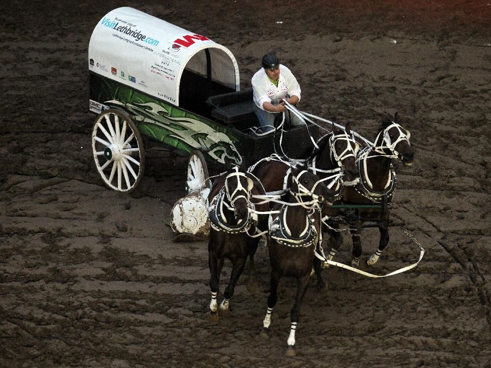 Wagon drivers battle through a half mile of mud at Stampede